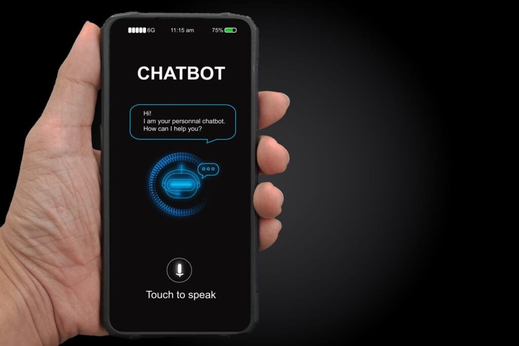 A man's hand holding mobile smartphone with chatterbot application